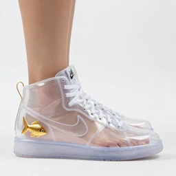 clear plastic nike high top sneakers made from clear plastic with a goldfish in the heel, bare feet visible inside