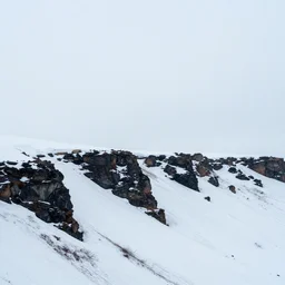 minimalist charred rocky snowdrift landscape with cliff contours from mulan ( 1 9 9 8 )