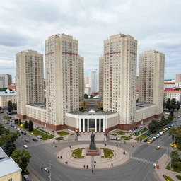 photo of a low income highrise geometric Russian city, apartments, train station, avenues. Square with a statue of leader