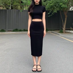 full body shot of a woman wearing a black crop top and a skirt