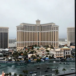 a real photo of las vegas viewed from a very far away wet skyscraper's window on a rainy day, by saul leiter