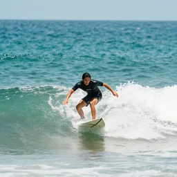 photo of a surfer, surfing in the waves, film photography