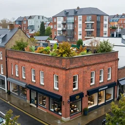 brick building, ground floor shops, residential apartments, rooftop garden. rainy atmosphere. sharp focus, smooth, hd, detailed, digital painting trending on art station.