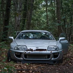 an abandoned toyota supra mk 4 in the woods