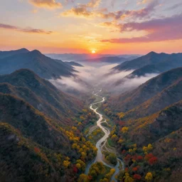 The most beautiful panoramic landscape taken by a dron, oil painting, where the mountains are towering over the valley below their peaks shrouded in mist. The sun is just peeking over the horizon and the sky is ablaze with colors. The river is winding its way through the valley and the trees are starting to turn yellow and red, by Greg Rutkowski, aerial view