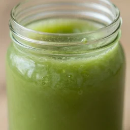 close - up shot of a mason jar filled with cloudy green slime, macro lens, depth of field, bokeh