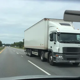 grainy low - res dashcam footage of 1 8 wheeler blocking the road, car dashcam recording
