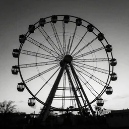 a photo of a large abandoned ferris wheel, old, eerie, black and white, night