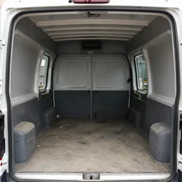 photo of interior view of the cargo compartment of a van, filthy, documentary photograph