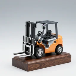 a small chrome - plated forklift truck trophy, on wooden base