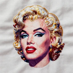 embroidered pattern of marilyn monroe's face on white linen fabric