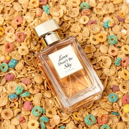 a bottle of By Kilian 'Love Don't Be Shy' perfume, the bottle of perfume is laying on cereal, the cereal is Kelloggs Fruity Pebbles, high resolution photo,