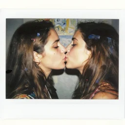 double exposure of two women kissing ( closeup ) and a bizarre painting, lomography. this photograph is subsequently printed out and splattered with paint. mixed media collage art with magazines and found art