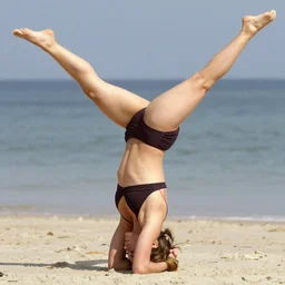 emma watson doing a headstand yoga pose in bikini