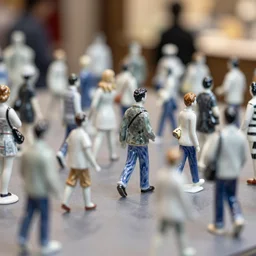 A street busy with walking porcelain people figurines close up, tilt shift, reflections, Canon TS-E 17mm f/4, pristine quality wallpaper