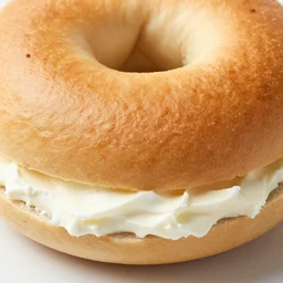 an extreme close up of a new york city bagel with cream cheese, mouth watering, 80mm macro lens