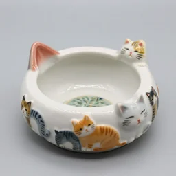 a photo of a close up of a special cat - shaped ashtray, decorated with cat figures