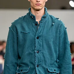 an award - winning closeup photo of a male model wearing a baggy teal distressed medieval cloth menswear jacket by raf simons, 4 k, studio lighting, wide angle lens