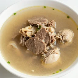 a photo of a soup full of beef pork and chicken, with a thick delicious roux with thick stock and huge chunks of freshly cooked meats, everything looks delicious and amazing for a coup that is essentially just meats and herbs with butter