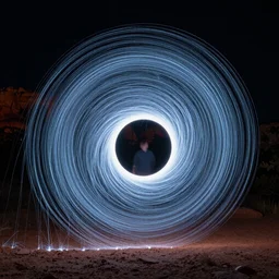 a light painting of a spiraling electromagnetic vortex using long exposure technique at night in sedona, arizona, hyper detailed, photorealistic, 3 d, rendered in octane, film, cinematic, dramatic lighting, 1 0 mm