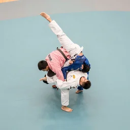 jiu jitsu athletes doing an extreme contortion choreography, dance photography, pastel colors palette, sport photography, high detail, aerial view, foreshortening, natural light