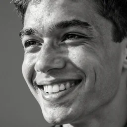 extremely close-up greyscale photo of GigaChad looking slightly to the left, grinning widely