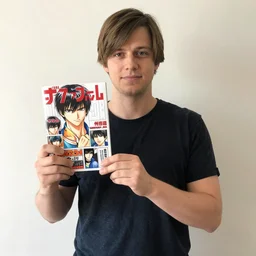john madden proudly holding up his favorite manga