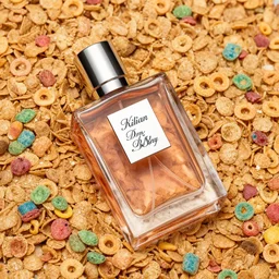 a bottle of Kilian perfume, Kilian Love Don't Be Shy, the bottle of perfume is laying on cereal, the cereal is Kelloggs Fruity Pebbles, high resolution photo,