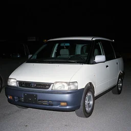 rounded 1990s car Toyota Previa, 70mm flash photography