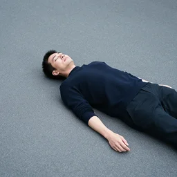 photography of a man lying on the ground of tokyo in the style of daido moriyama, street photography, 1 4 mm lens, grainy wb image