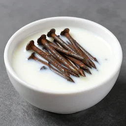 dslr food photograph of a a bowl filled with rusty nails and milk with a spoon placed on the table next to it, 8 5 mm f 1. 8