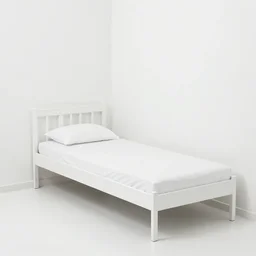 a small single white bed in the corner of a white room