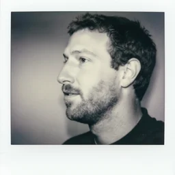 manly mark zuckerberg with stubble and big!! square chin!!!, sideways, black and white photography, polaroid, depth of field, maximum detail, high quality, soft light, focus