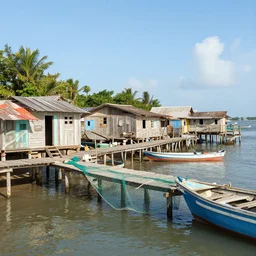 a little fisher village in cuba, wood pier and houses, nets and boats, house made with boat parts, scenic view, bright day, hyper realistic, matte painting by marc simonetti and rhads and donato giancola, trending on artstation