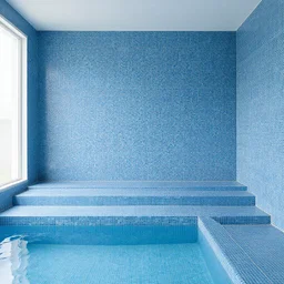 windowless hall with small blue tiles, steps to a a water pool