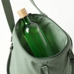 green bottle inside a shoulder bag