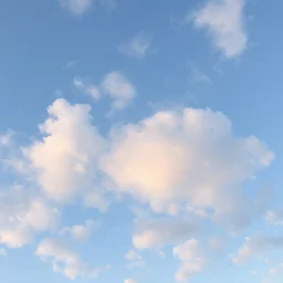 puffy clouds sky sparse