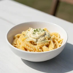 a bowl of pasta on a picnic table