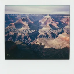 the grand canyon made of concrete, looking down, foggy, megalophobia, old polaroid, expired film,