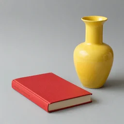 A red book and a yellow vase.