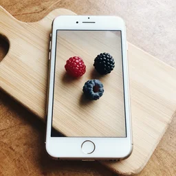 mobile photo of few berries lie on a cutting board on the table, iphone camera