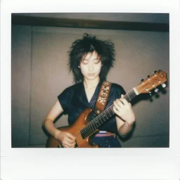 1 9 7 0 s polaroid of a female japanese folk musician with messy hair, hazy, faded
