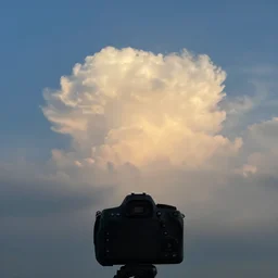a cloud swalling the sun in the afternoon, global light, photorealistic, photo taken from dslr camera