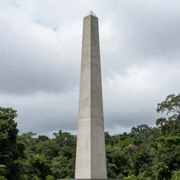 Rainforest in a cloudy day, concrete obelisk in the center