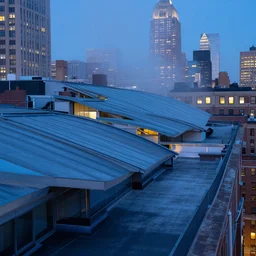 curved roof planes lift and descend creating shade and architectural expression, on a rooftop in manhattan, highly detailed, vivid color, high resolution photography, mist, dusk