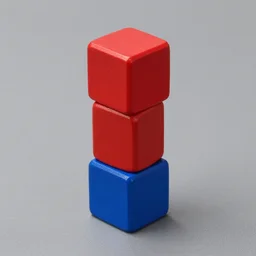 ( ( red cube ) at the top of tower ), ( ( blue cube ) on the ground )