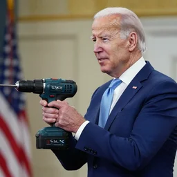 joe biden using a cordless drill