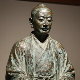 close up shot of an old bronze patina statue of kitano takeshi in a museum