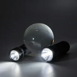 flashlight next to a glass ball