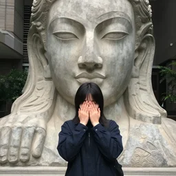a dear in front of giant statue, megalophobia